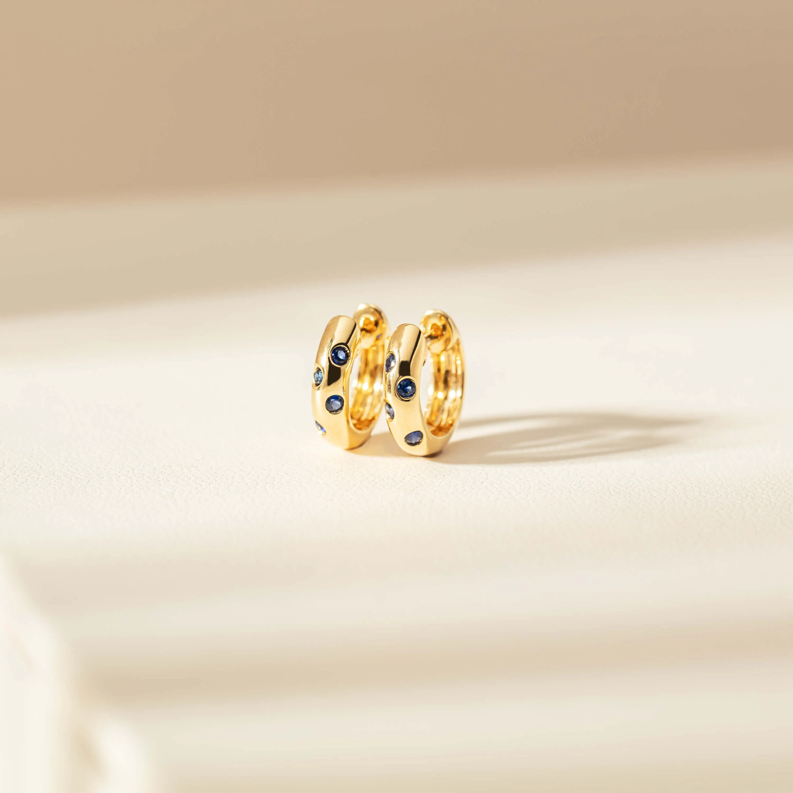 18ct Yellow Gold .18ct Sapphire Lucky Huggie Earrings